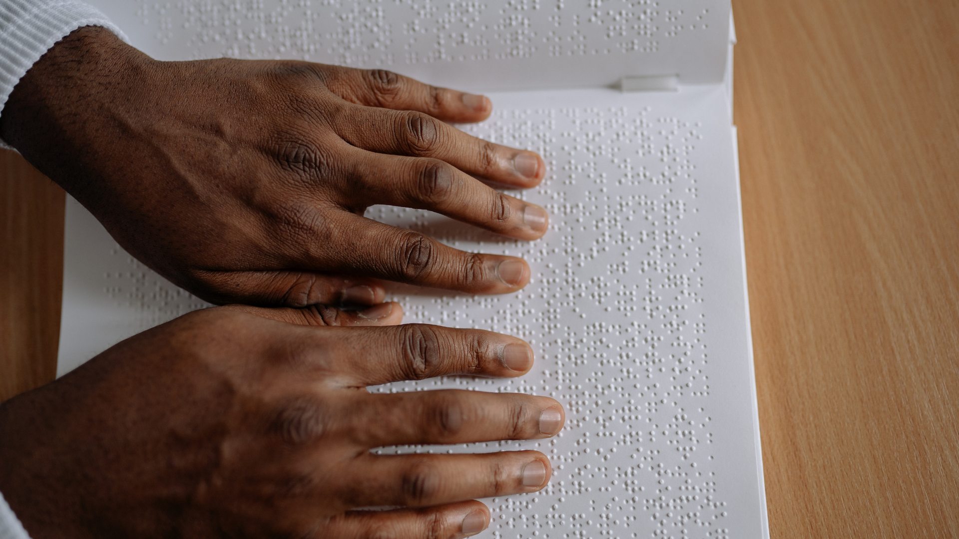 Blind student reading braille.
