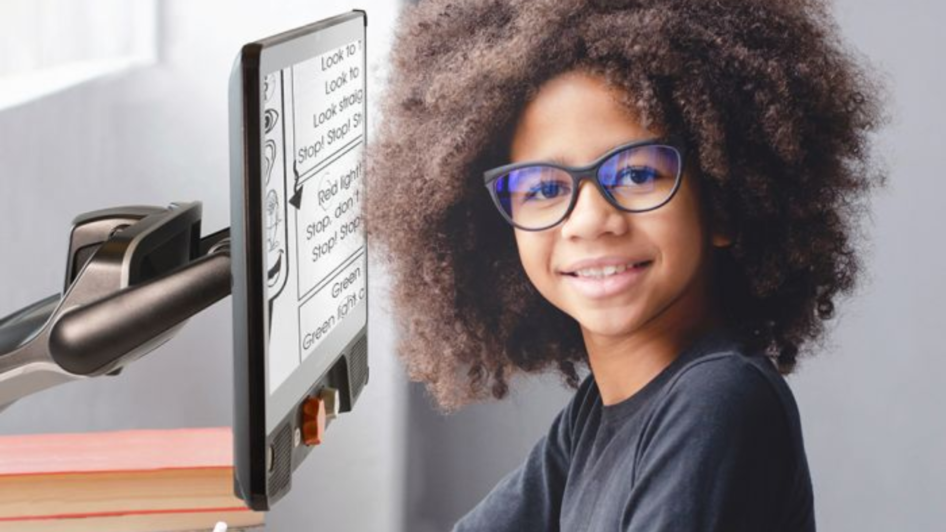 Young woman using a Reveal 16i video magnifier (cctv).