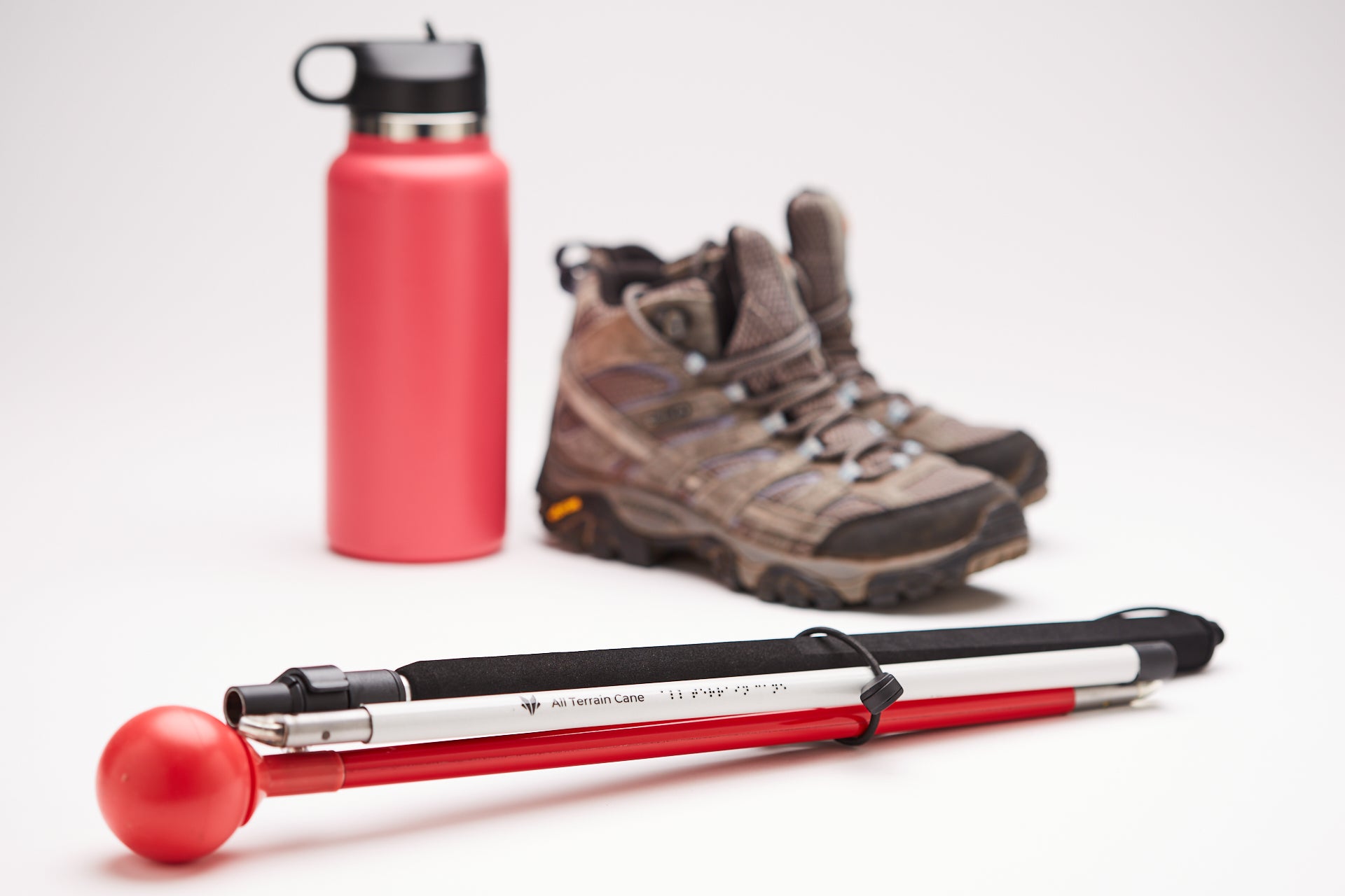 Awarewolf Gear All Terrain Cane next to hiking boots.