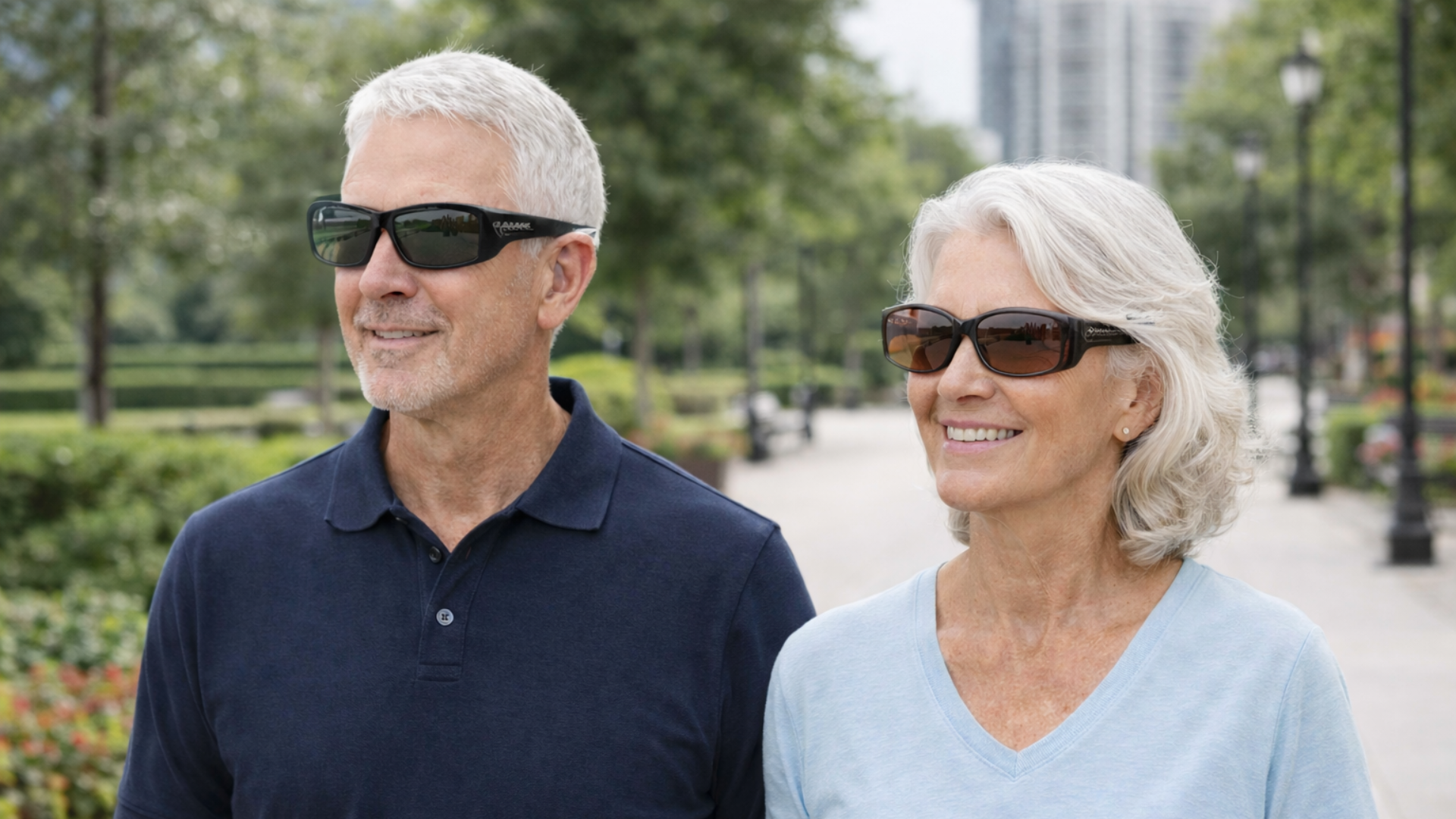 Two people wearing polarized sunglasses in an outdoor setting with tree