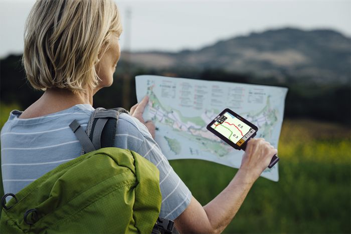 Woman using the explore5 to read a map.