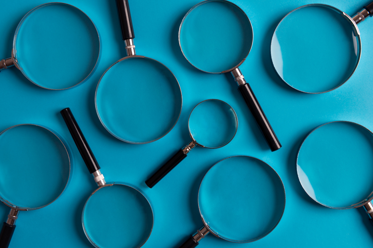 Image of several hand-held lens magnifying glasses on a table.