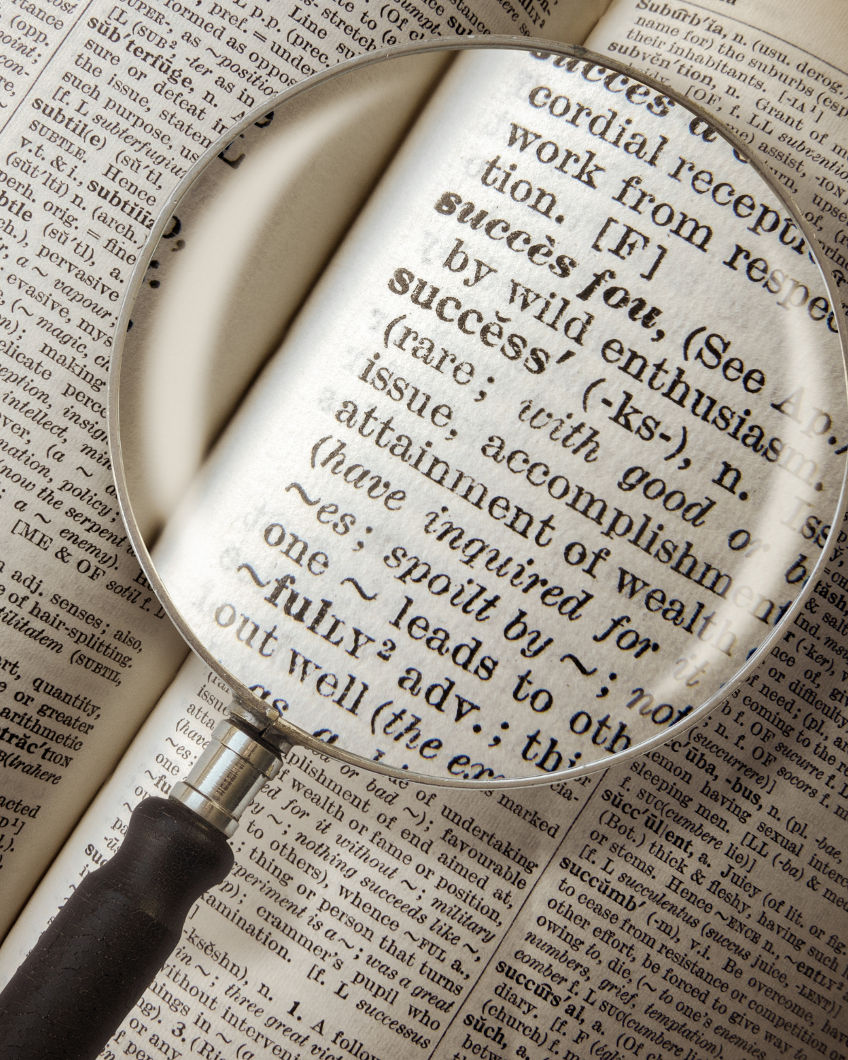 Round magnifying glass magnyfing text on paper.