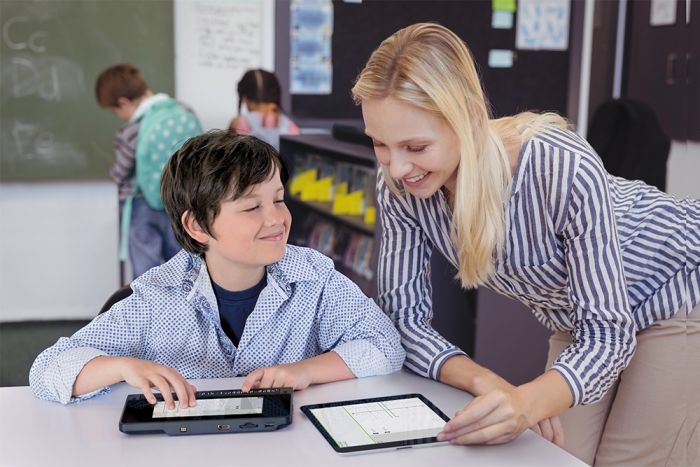Student using the BrailleNote Touch Plus with their teacher.
