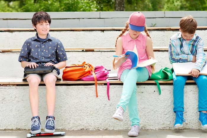 Child using the BrailleNote Touch Plus in public.