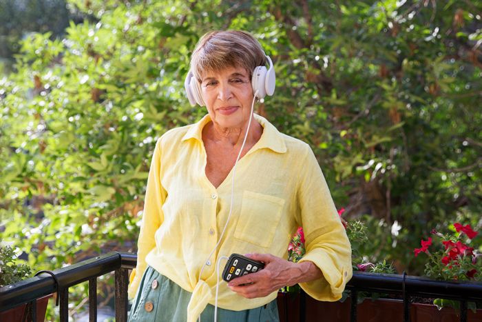 Woman using the Victor Reader Stream 3.