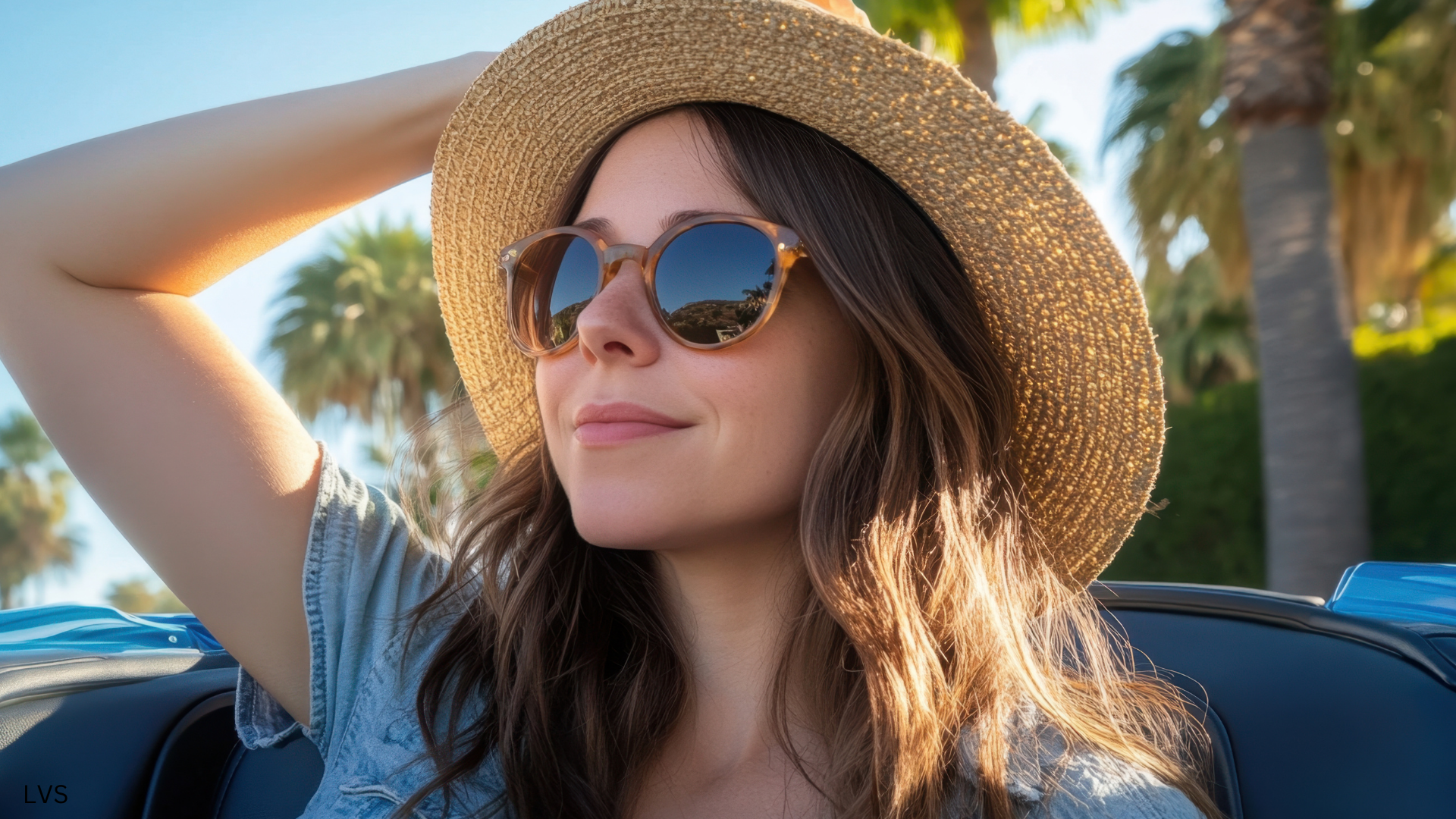 Woman in a hat wearing sunglasses.