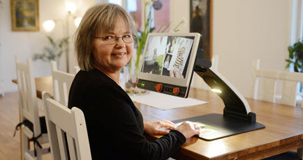 Woman sitting in front of MagniLink Zip.