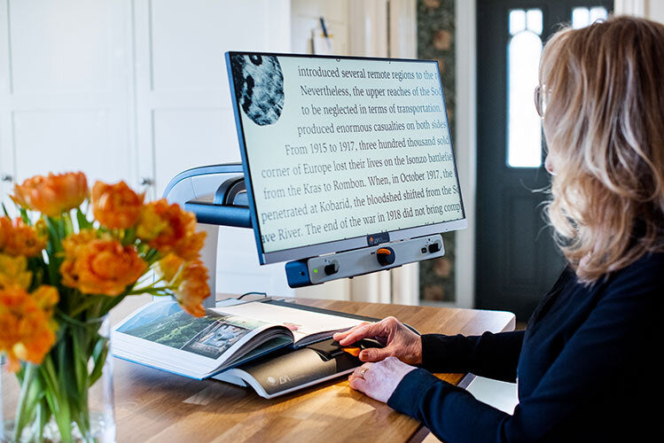 Woman using MagniLink Vision at a desk.