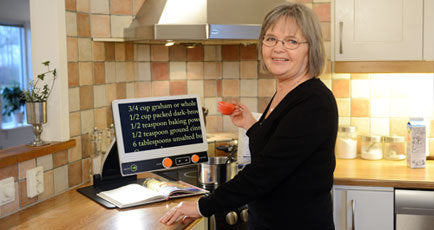 Woman standing in front of MagniLink Zip on table.