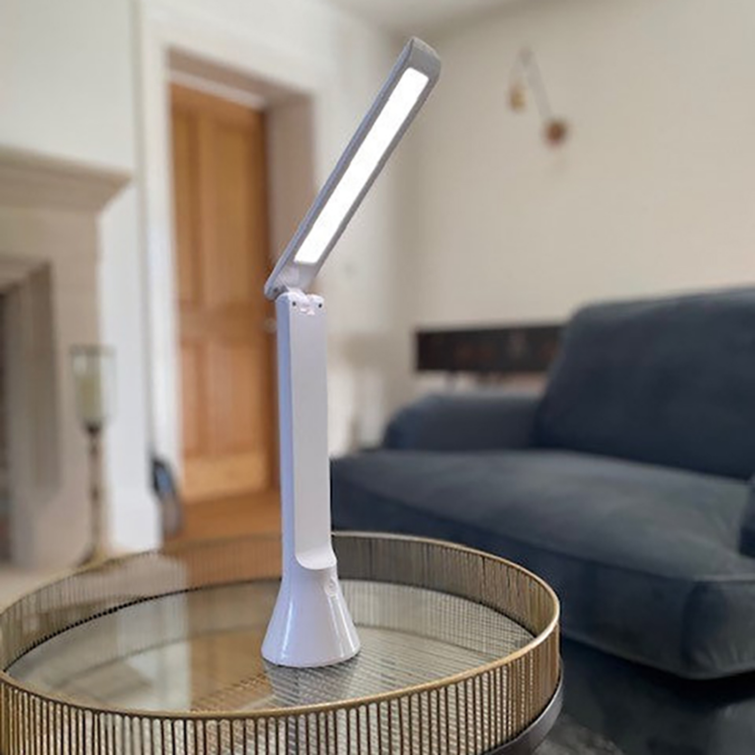 Cordless travel lamp on a table in a living space.