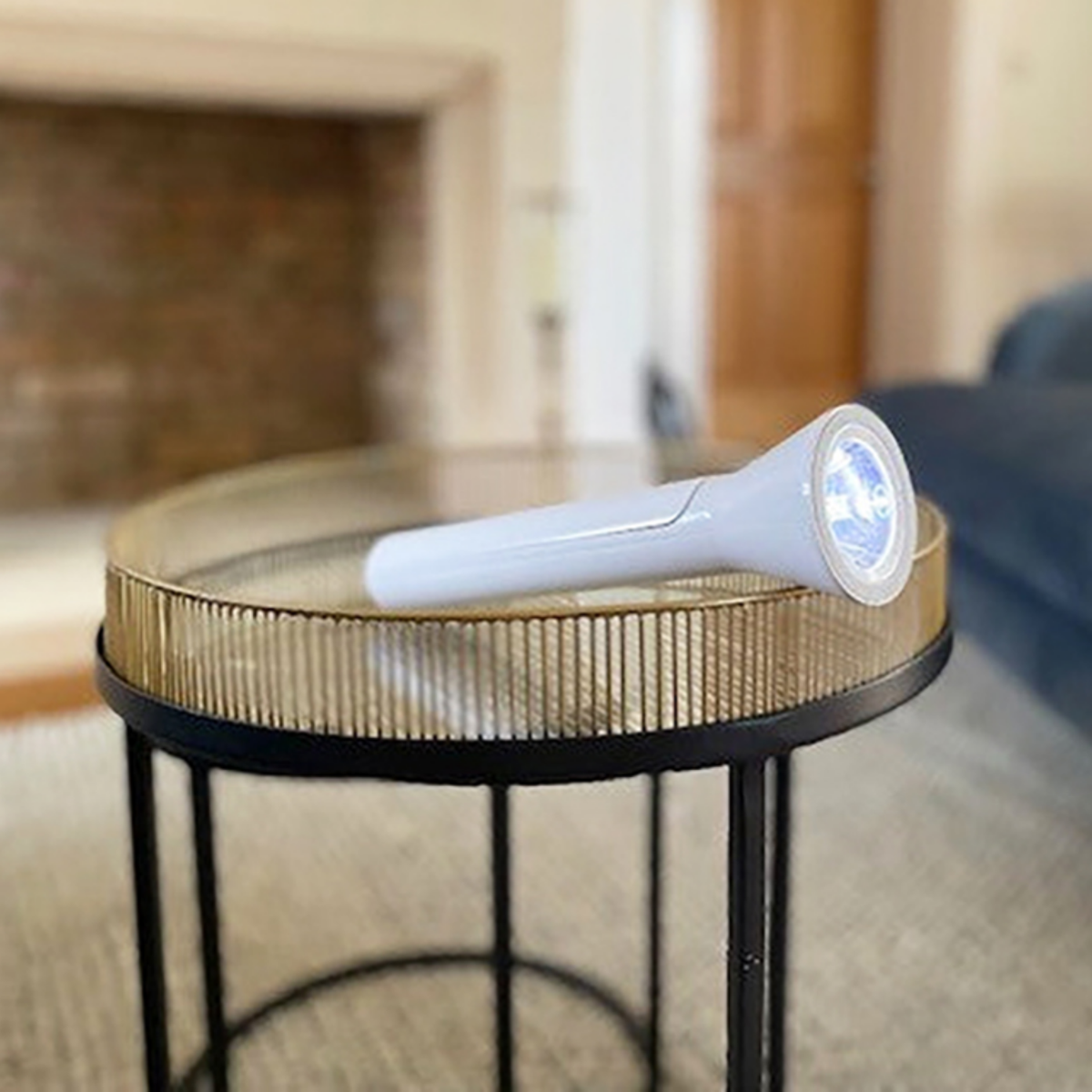 White travel light in it's folded flashlight configuration on a table.
