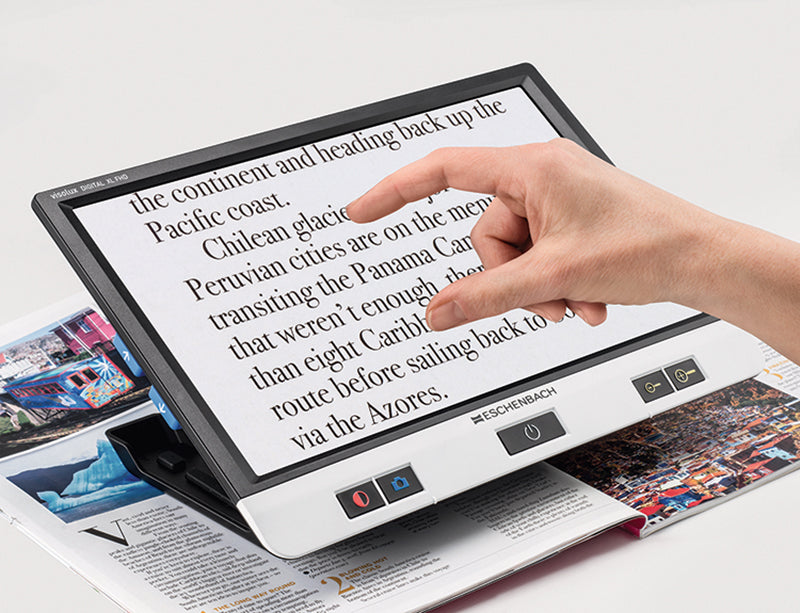 Image showing a hand enlarging text on a 12" Visolux digital video magnifier from Eschenbach Optik
